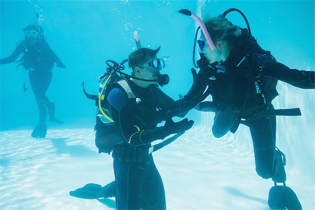 Friends on scuba training submerged in swimming pool on their holidays Stock Photo - Budget Royalty-Free & Subscription, Code: 400-07583496