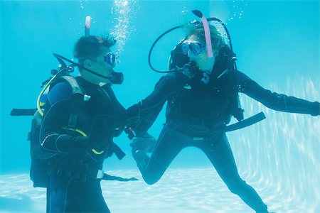 Friends on scuba training submerged in swimming pool  on their holidays Stock Photo - Budget Royalty-Free & Subscription, Code: 400-07583497