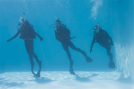 Three friends on scuba training submerged in swimming pool on their holidays Stock Photo - Budget Royalty-Free & Subscription, Code: 400-07583492