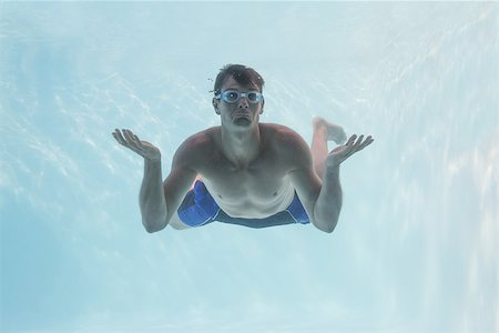 shoulder shrug - Man shrugging shoulders underwater in swimming pool on his holidays Stock Photo - Budget Royalty-Free & Subscription, Code: 400-07583621