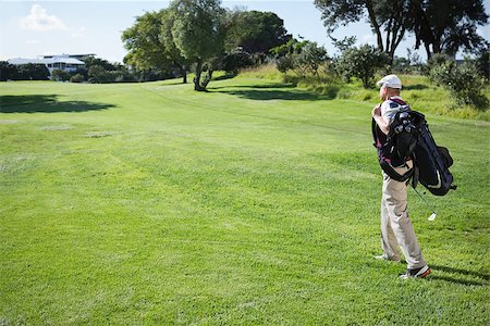 Golf player carrying his bag and walking on a sunny day at the golf course Stock Photo - Budget Royalty-Free & Subscription, Code: 400-07583688