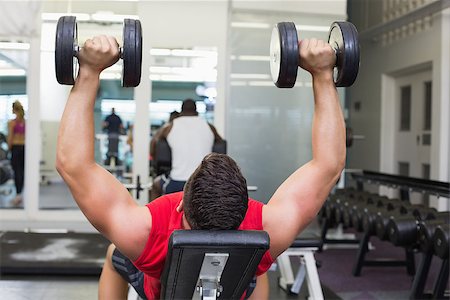 simsearch:400-07333355,k - Bodybuilder lying on bench lifting dumbbells at the gym Stock Photo - Budget Royalty-Free & Subscription, Code: 400-07583983