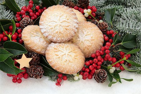 Christmas mince pie cakes with holly, mistletoe and snow covered fir. Stock Photo - Budget Royalty-Free & Subscription, Code: 400-07614214