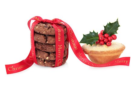 Mince pie and chocolate chip cookie biscuit stack with merry christmas red ribbon and holly over white background. Stock Photo - Budget Royalty-Free & Subscription, Code: 400-07614227