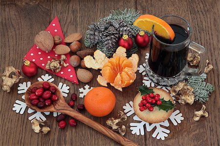 Christmas food with mulled wine ingredients of citrus fruit and spices with nuts and mince pie over oak background. Stock Photo - Budget Royalty-Free & Subscription, Code: 400-07614282