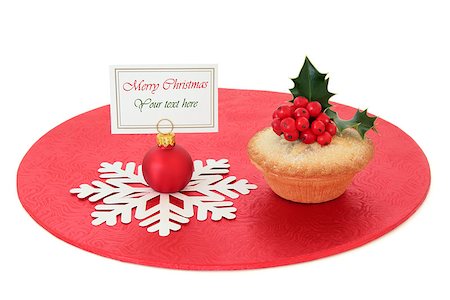 Christmas mince pie cake with holly and red bauble with name place setting tag over white background. Stock Photo - Budget Royalty-Free & Subscription, Code: 400-07614293