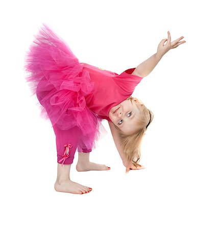little girl in a pink dress dancing in the studio bow isolated on white background Photographie de stock - Aubaine LD & Abonnement, Code: 400-07615702