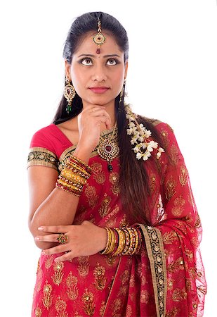 Portrait of beautiful young Indian female in traditional sari dress thinking, looking up, standing isolated on white background. Stock Photo - Budget Royalty-Free & Subscription, Code: 400-07616585