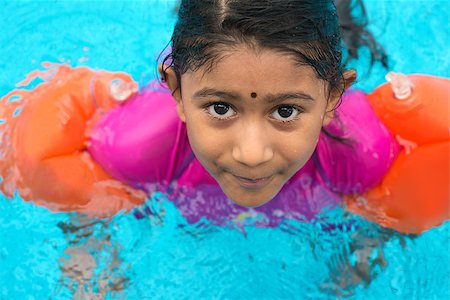 Indian child learning swimming in pool. Asian girl in swimmer class with float bands. Stock Photo - Budget Royalty-Free & Subscription, Code: 400-07616594
