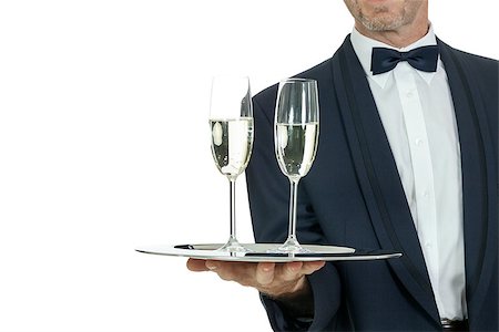 simsearch:400-05230474,k - adult male waiter serving two glass of champagne isolated on white Stock Photo - Budget Royalty-Free & Subscription, Code: 400-07617700