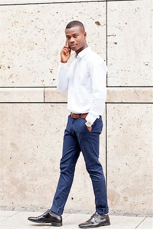 young successfil african businessman with mobilephone talking walking outdoor Stock Photo - Budget Royalty-Free & Subscription, Code: 400-07617916