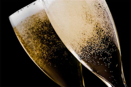 detail of two flutes with champagne gold bubbles on black background Stock Photo - Budget Royalty-Free & Subscription, Code: 400-07618416