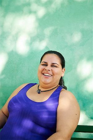 Portrait of overweight hispanic woman looking at camera and smiling Stock Photo - Budget Royalty-Free & Subscription, Code: 400-07619097