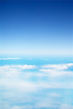 clouds in a blue sky, view from airplane Foto de stock - Super Valor sin royalties y Suscripción, Código: 400-07619499
