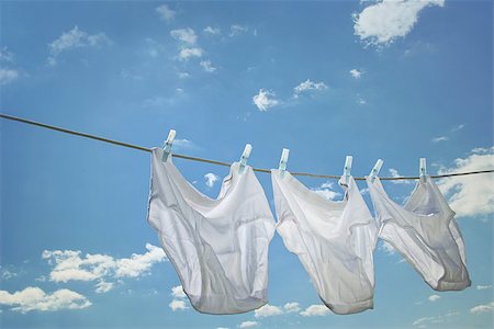 Men's underwear hanging on clothesline against blue sky Stock Photo - Budget Royalty-Free & Subscription, Code: 400-07624011