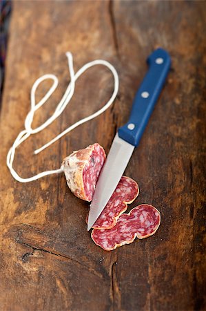 simsearch:400-06852716,k - slicing italian salame pressato pressed over old wood table Stockbilder - Microstock & Abonnement, Bildnummer: 400-07624147