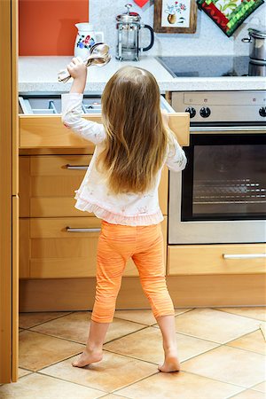 Little girl getting tableware from table case before dinner Stock Photo - Budget Royalty-Free & Subscription, Code: 400-07624275
