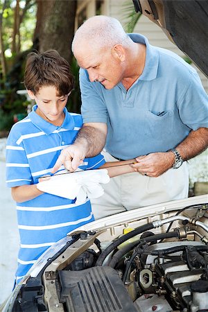 Father teaching his son how to check the oil on the family car. Stock Photo - Budget Royalty-Free & Subscription, Code: 400-07624426