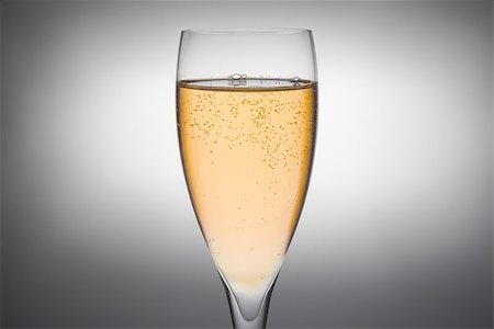 effervescing - flute of champagne with gold bubbles on a grey background Stock Photo - Budget Royalty-Free & Subscription, Code: 400-07624422