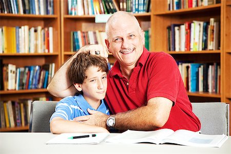 simsearch:400-08034926,k - Annoying father teasing his son when they are supposed to be studying at the library. Stock Photo - Budget Royalty-Free & Subscription, Code: 400-07624445