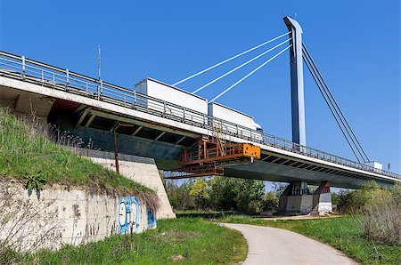 White truck on move fast on modern road bridge over narrow walkway in the park in Piedmont, Italy. Stock Photo - Budget Royalty-Free & Subscription, Code: 400-07625143