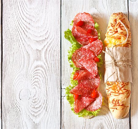 simsearch:400-07792940,k - Salami sandwich with lettuce and sweety drop peppers on a white wooden board with place for text. Stock Photo - Budget Royalty-Free & Subscription, Code: 400-07626146