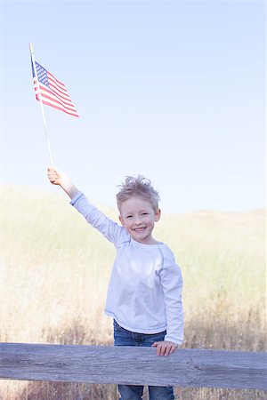 simsearch:400-07626725,k - little boy holding american flag and celebrating 4th of July Photographie de stock - Aubaine LD & Abonnement, Code: 400-07626727