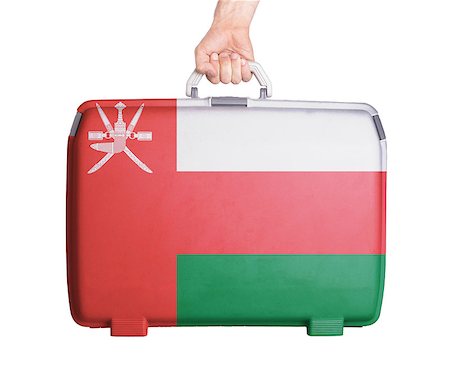 Used plastic suitcase with stains and scratches, printed with flag, Oman Stock Photo - Budget Royalty-Free & Subscription, Code: 400-07626954