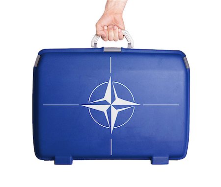 Used plastic suitcase with stains and scratches, printed with flag, NATO Stock Photo - Budget Royalty-Free & Subscription, Code: 400-07626953