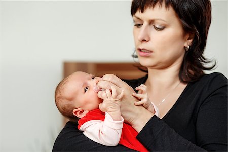 pacifier mom holding - mother with her cute little baby girl, first month of the new life, focus to infant, adjusting pacifier Stock Photo - Budget Royalty-Free & Subscription, Code: 400-07627034