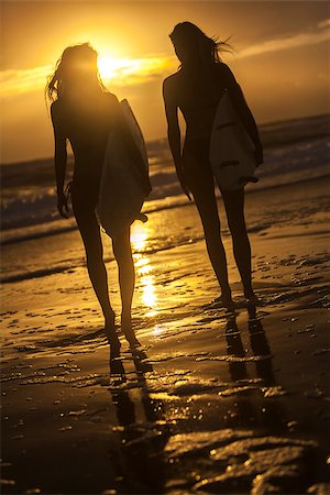 surfboard beach sunset friends - Beautiful young women surfer girls in bikinis with surfboards on a beach at sunset or sunrise Stock Photo - Budget Royalty-Free & Subscription, Code: 400-07627308