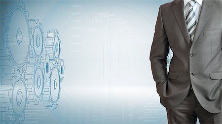 people hi tech data - Businessman standing with hands in pockets. High-tech wire frame gears and graphs at backdrop Stock Photo - Budget Royalty-Free & Subscription, Code: 400-07627440