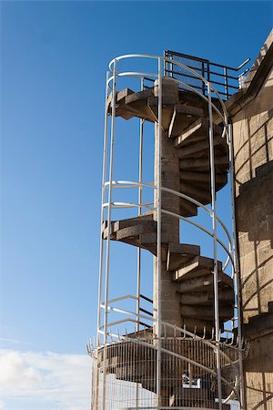 photojope (artist) - Outdoors spiral staircase in a building with blue sky as background. Photographie de stock - Aubaine LD & Abonnement, Code: 400-07627800