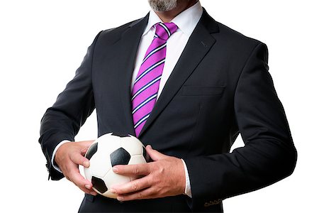 Business man in dark suit and tie holds a soccer ball Stock Photo - Budget Royalty-Free & Subscription, Code: 400-07628284