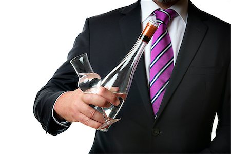 Business man in dark suite with a grappa glas and a bottle with alcohol Photographie de stock - Aubaine LD & Abonnement, Code: 400-07628299
