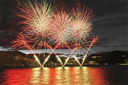 Lakefront Luino fireworks on the Maggiore lake in summer evening, Lombardy - Italy Foto de stock - Royalty-Free Super Valor e Assinatura, Número: 400-07628419