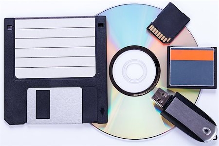 floppy disk - Selection of different computer storage devices for data and information including a CD-DVD, floppy disc, USB key, compact flash card and SD card viewed in a neat arrangement from overhead Stock Photo - Budget Royalty-Free & Subscription, Code: 400-07629923