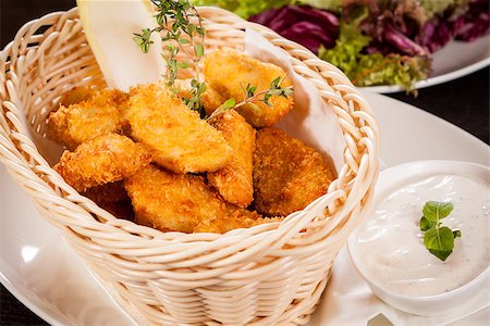 simsearch:400-05708291,k - Crispy fried crumbed chicken nuggets in a wicker basket served as a finger food or appetizer with a creamy dip in a bowl alongside Stock Photo - Budget Royalty-Free & Subscription, Code: 400-07629998