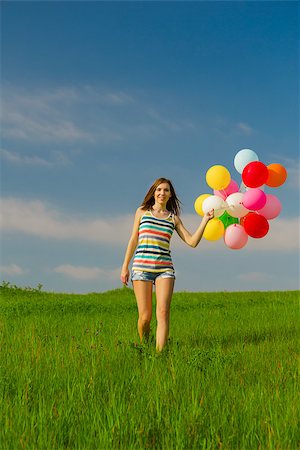photo girl walking with balloon - Young beautiful woman with colorful balloons on a green meadow Stock Photo - Budget Royalty-Free & Subscription, Code: 400-07620004