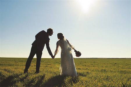 photo poses for suited dress - Young newly wed couple at field. Groom and bride together. Stock Photo - Budget Royalty-Free & Subscription, Code: 400-07620309