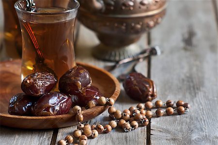 Traditional arabic tea with wooden rosary and dry madjool dates . Selective focus. Stock Photo - Budget Royalty-Free & Subscription, Code: 400-07620938