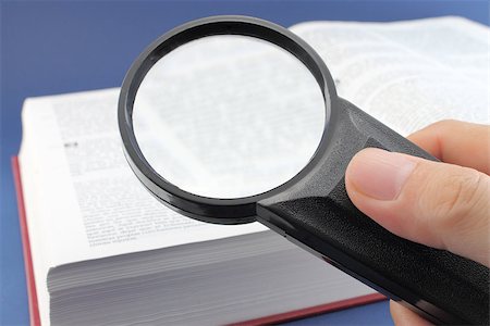 photoestelar (artist) - Hand with a magnifying glass on a book page. Referred to the reading and knowledge conceptual image. Stock Photo - Budget Royalty-Free & Subscription, Code: 400-07620975