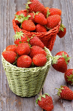 simsearch:400-08020671,k - Sweet Forest Strawberries in Red and Green Wicker Baskets isolated on Rustic Wooden background Stock Photo - Budget Royalty-Free & Subscription, Code: 400-07621010