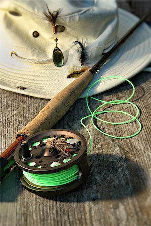 decoy - Close-up of fly-fishing reel and rod with canvas hat Stock Photo - Budget Royalty-Free & Subscription, Code: 400-07621398