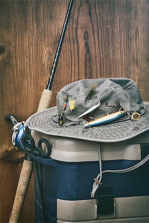 simsearch:400-08258030,k - Hat with fishing equipment against wood wall Stock Photo - Budget Royalty-Free & Subscription, Code: 400-07621404