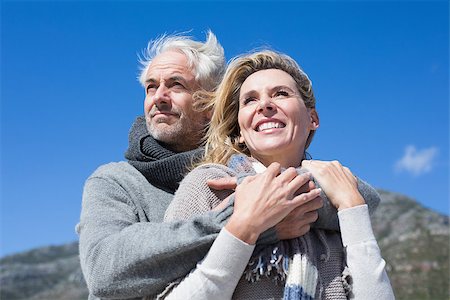 Carefree couple hugging in warm clothing on a bright but cool day Stock Photo - Budget Royalty-Free & Subscription, Code: 400-07622730