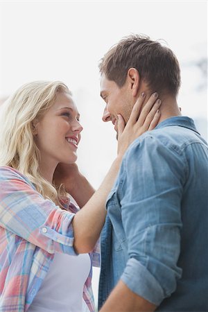 Cute young couple standing and facing each other on a sunny day in the city Stock Photo - Budget Royalty-Free & Subscription, Code: 400-07623260