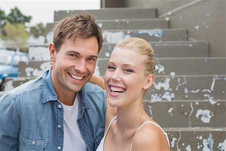 Hip young couple sitting on steps smiling at camera on a sunny day in the city Stock Photo - Budget Royalty-Free & Subscription, Code: 400-07623394