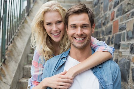 Hip young couple sitting on steps smiling at camera on a sunny day in the city Stock Photo - Budget Royalty-Free & Subscription, Code: 400-07623407