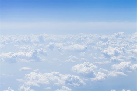Blue sky with clouds background. View from airplane Foto de stock - Super Valor sin royalties y Suscripción, Código: 400-07623950